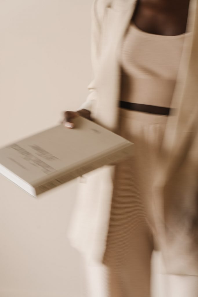 A woman holding a book on mindset