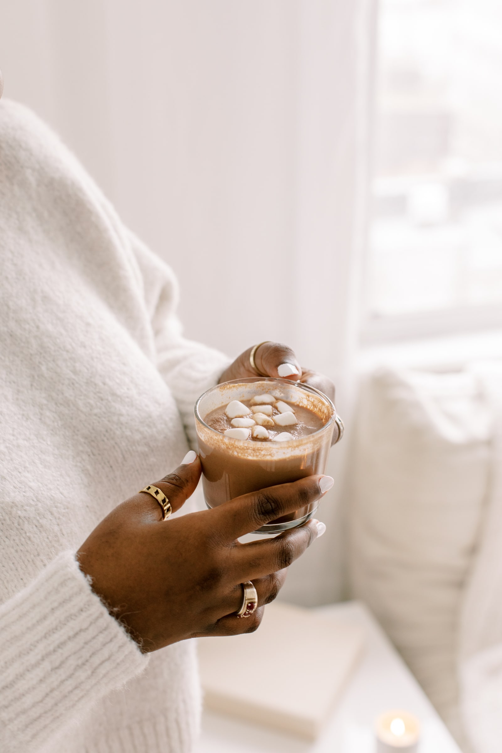 A woman drinking a hot chocolate (close up)