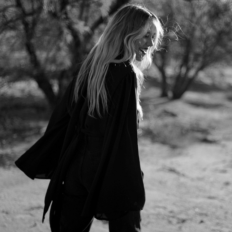 A woman smiling, turning slightly toward the camera (the art of softening post)