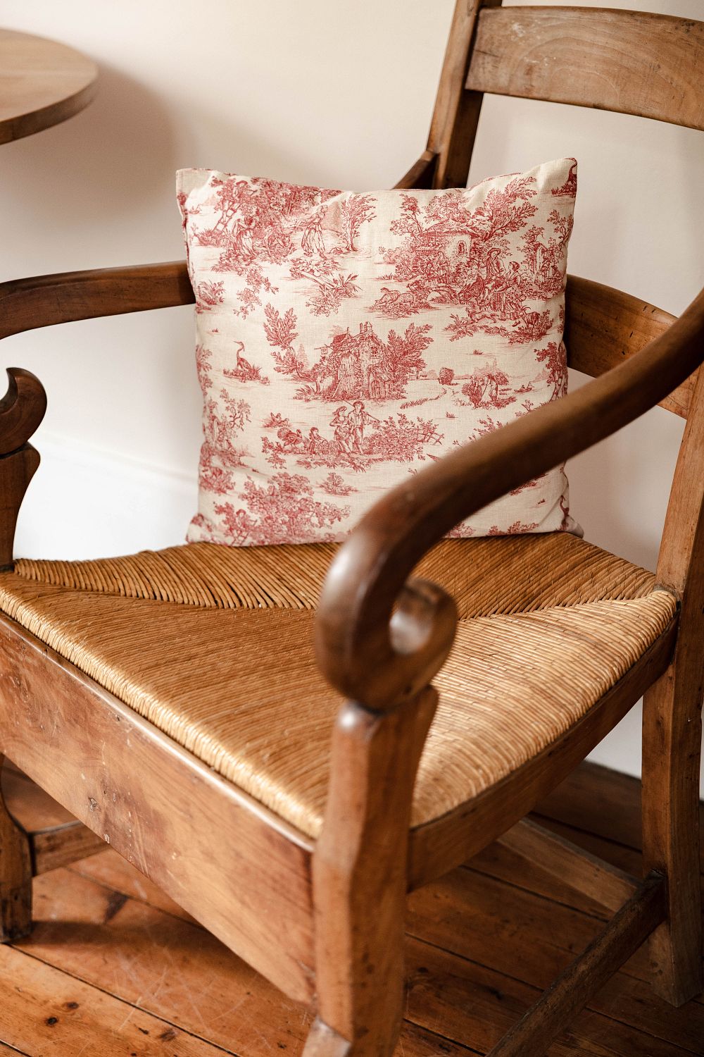 A beautiful image of an old chair with a cushion on